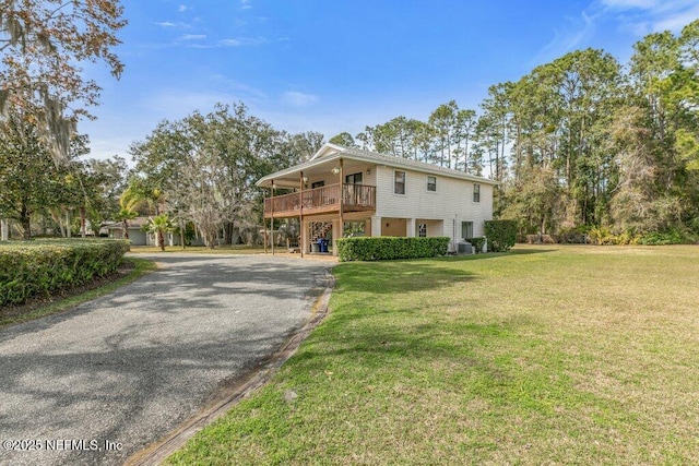 view of home's exterior featuring a yard and driveway