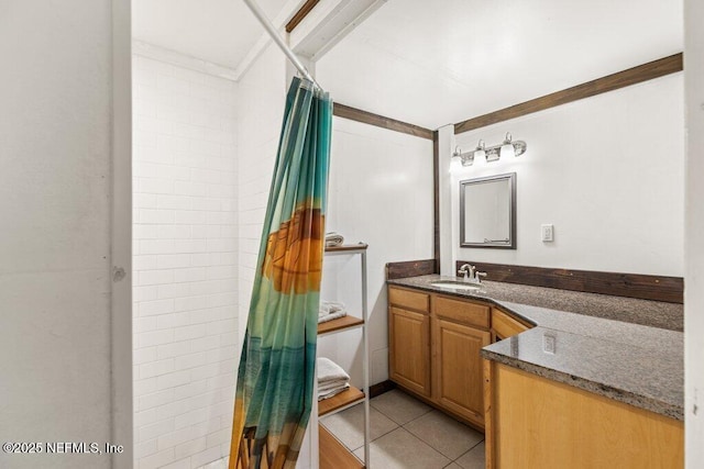 full bathroom with ornamental molding, a tile shower, vanity, and tile patterned floors