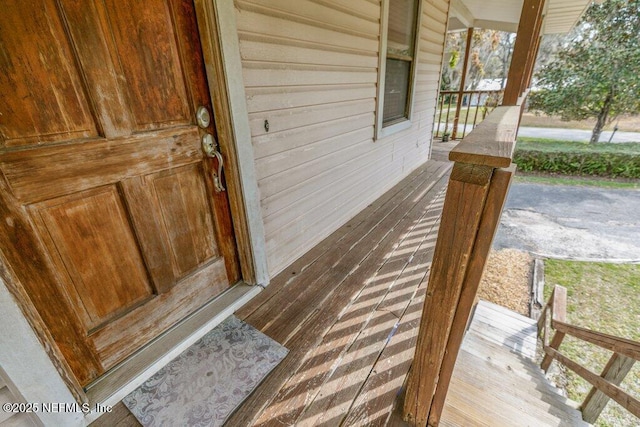 view of exterior entry with a porch