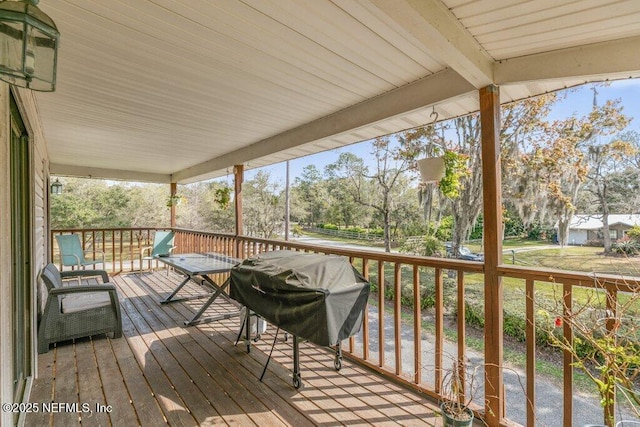 wooden terrace featuring area for grilling