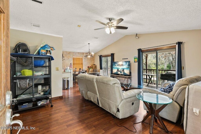 living room with visible vents, dark wood-style flooring, vaulted ceiling, a textured ceiling, and ceiling fan with notable chandelier