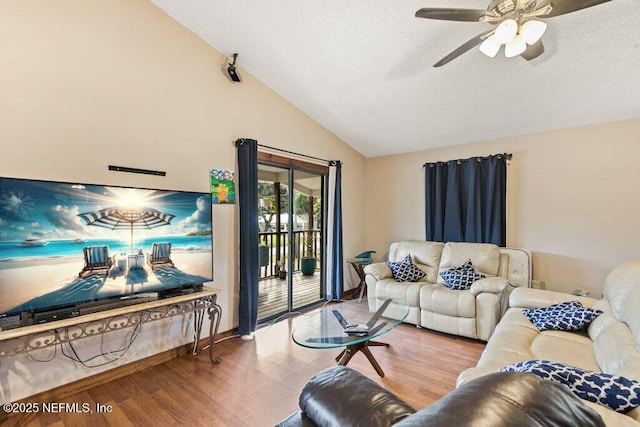 living room featuring a ceiling fan, vaulted ceiling, and wood finished floors