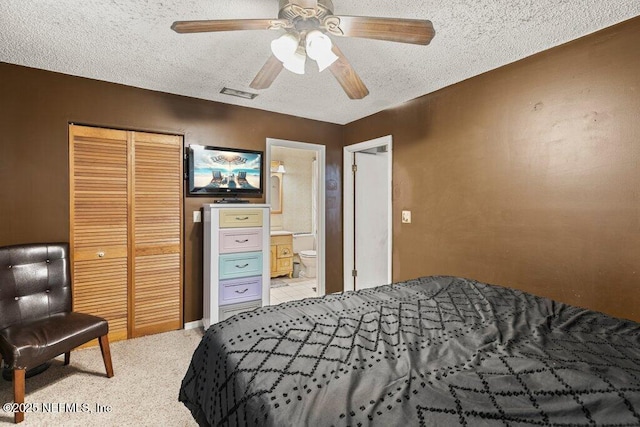 bedroom with a closet, visible vents, ceiling fan, and a textured ceiling