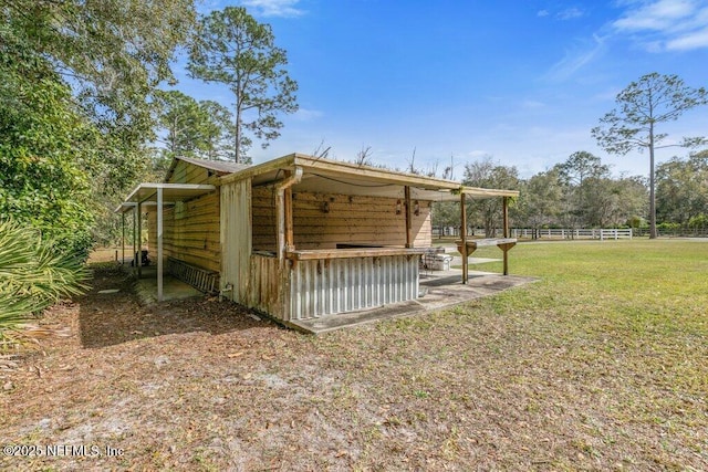 exterior space featuring a yard and fence