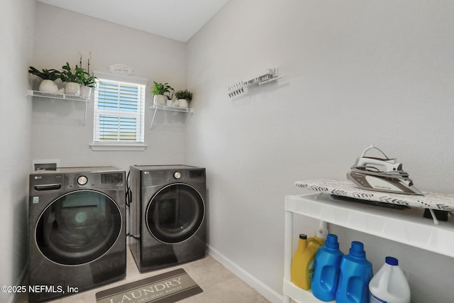 laundry room featuring laundry area, washer and clothes dryer, and baseboards