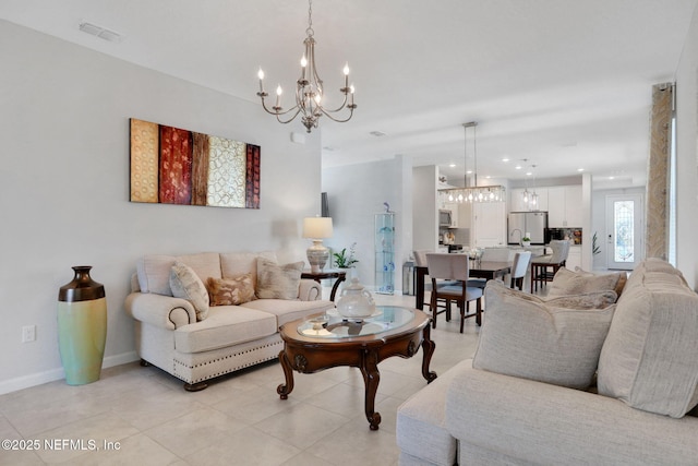 living room with light tile patterned floors, baseboards, visible vents, and a chandelier