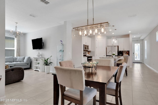 dining area with a notable chandelier, light tile patterned floors, recessed lighting, visible vents, and baseboards