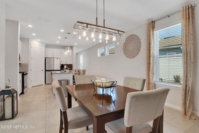 dining area with recessed lighting, light tile patterned flooring, and baseboards