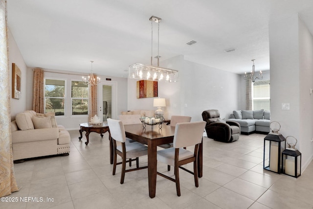 dining room with light tile patterned floors, visible vents, a chandelier, and baseboards