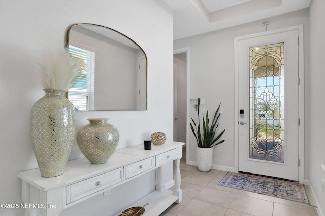 entryway featuring baseboards and light tile patterned flooring