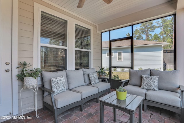 sunroom / solarium featuring wood ceiling and a ceiling fan