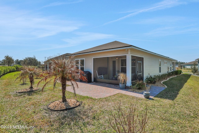 rear view of house featuring a patio area, a sunroom, and a yard