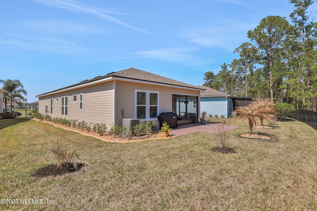 back of house featuring a patio area, a lawn, and central AC