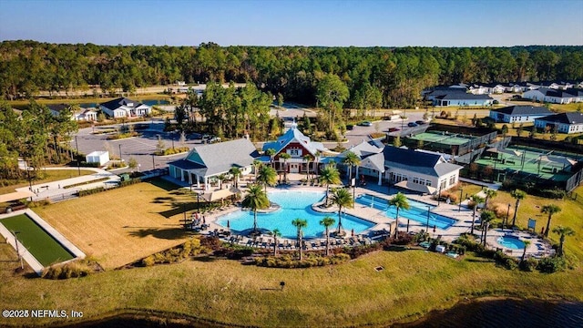 birds eye view of property featuring a forest view