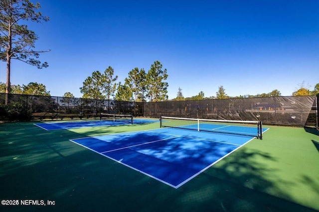 view of tennis court with fence