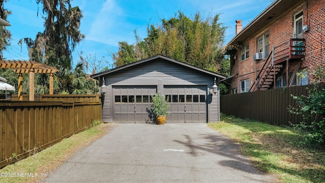 detached garage featuring fence