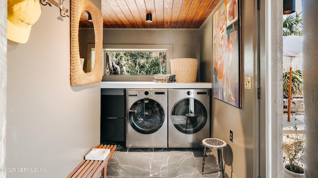 laundry room featuring laundry area, wood ceiling, marble finish floor, and washer and clothes dryer