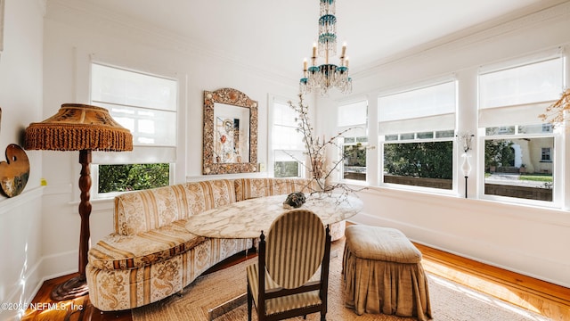 dining room featuring breakfast area, a wealth of natural light, and crown molding