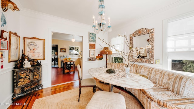 dining space with a wealth of natural light, crown molding, and wood finished floors