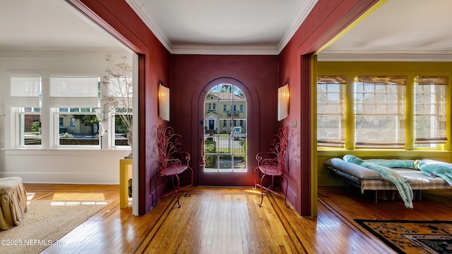 entryway with wood-type flooring and crown molding