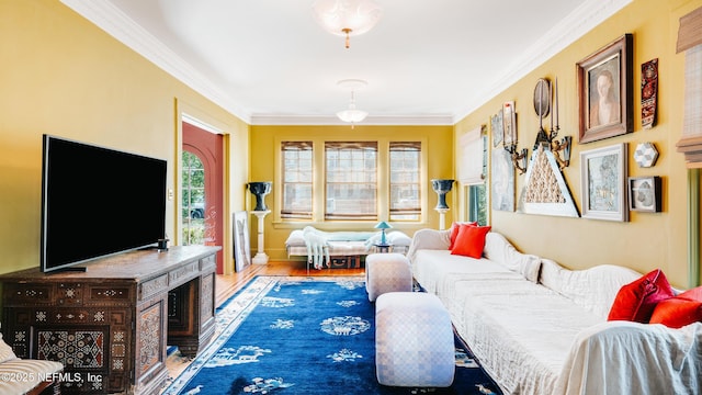 bedroom with baseboards, ornamental molding, and wood finished floors