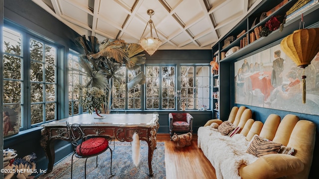 playroom featuring coffered ceiling and wood finished floors