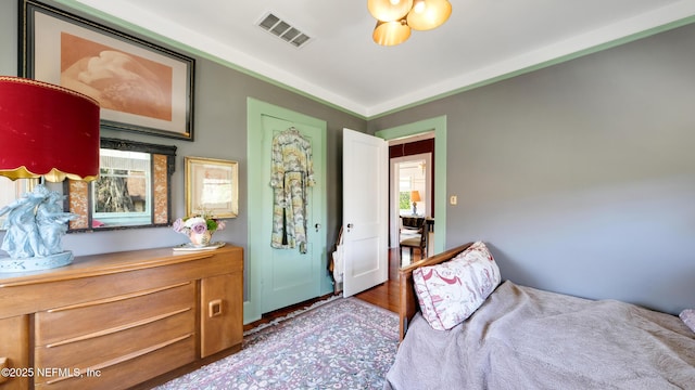 bedroom with wood finished floors and visible vents