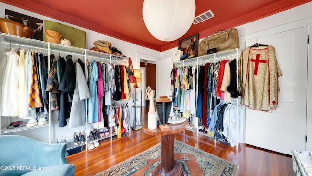 spacious closet featuring visible vents and wood finished floors