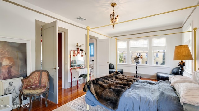 bedroom with visible vents and wood finished floors