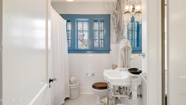 bathroom featuring tile walls, toilet, and tile patterned floors