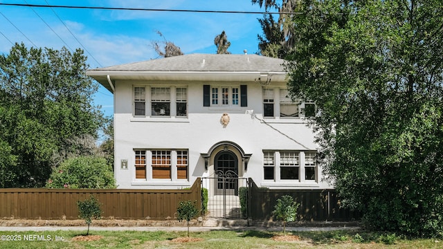 view of front of house featuring a fenced front yard and stucco siding