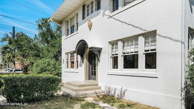 view of exterior entry with stucco siding