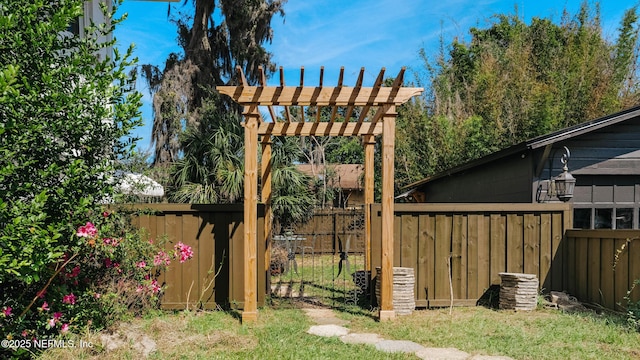 view of yard featuring fence and a pergola