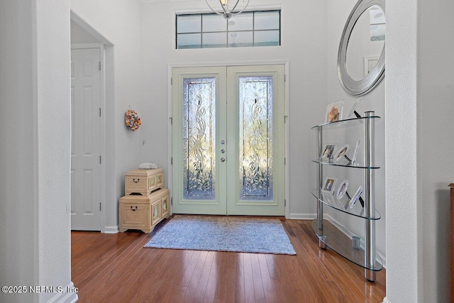 entrance foyer with french doors, baseboards, and wood-type flooring