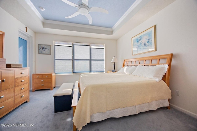 bedroom featuring a raised ceiling, carpet flooring, and crown molding