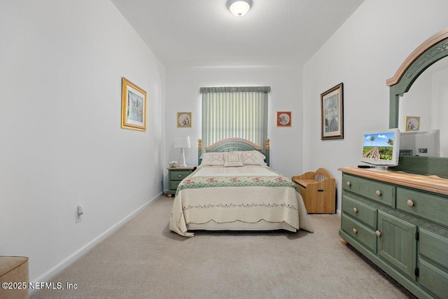 bedroom featuring baseboards and light colored carpet