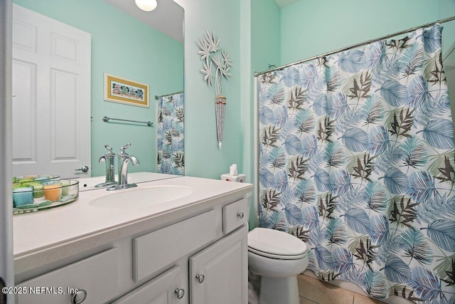 bathroom featuring vanity, toilet, and tile patterned floors