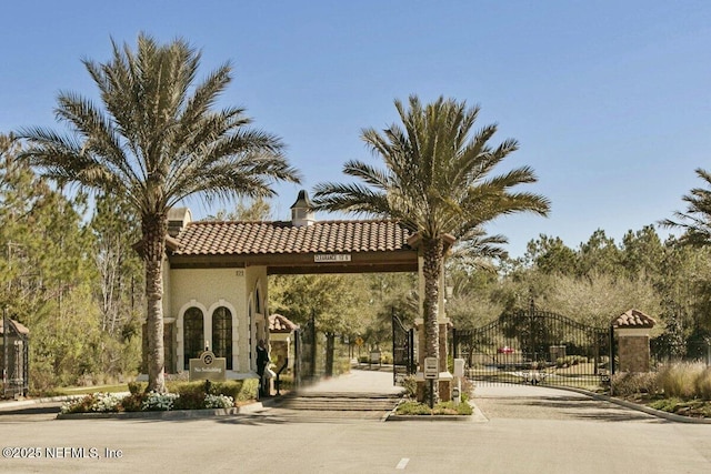 view of home's community with a gate