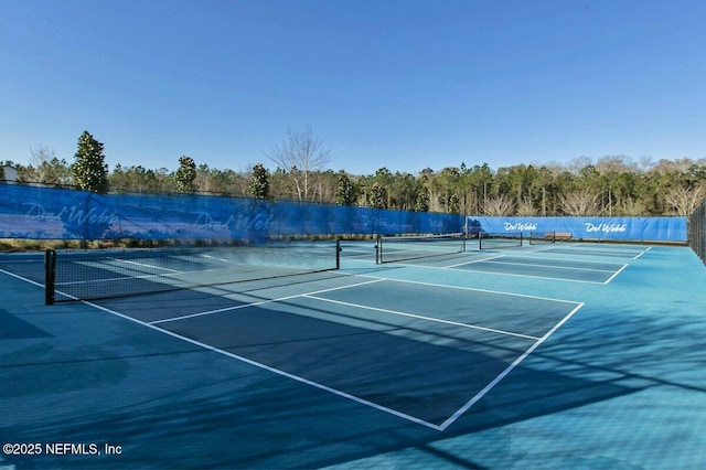 view of sport court with fence