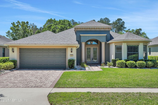 ranch-style house with french doors, an attached garage, decorative driveway, and stucco siding