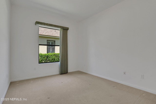 spare room featuring baseboards and carpet floors
