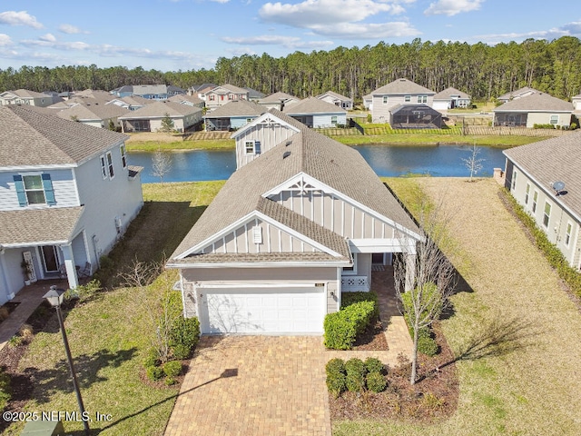 birds eye view of property with a water view and a residential view