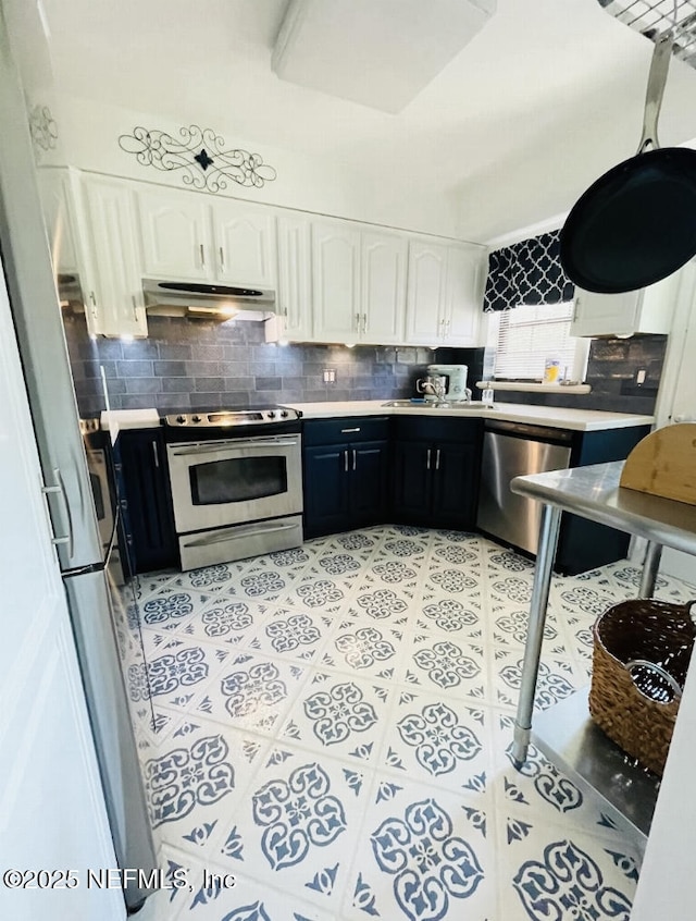 kitchen with white cabinets, under cabinet range hood, stainless steel appliances, and light tile patterned flooring