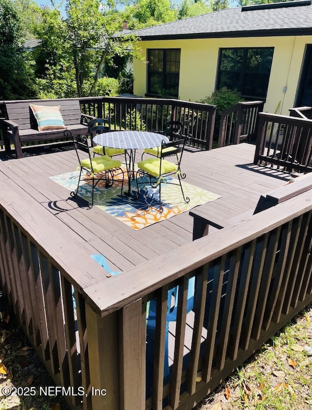 deck featuring outdoor dining area