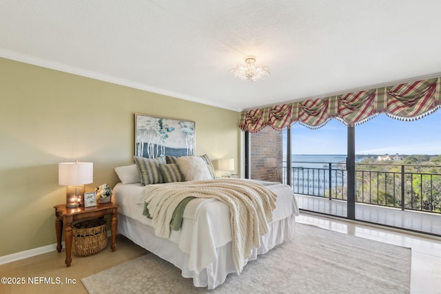 bedroom featuring access to outside, baseboards, and ornamental molding