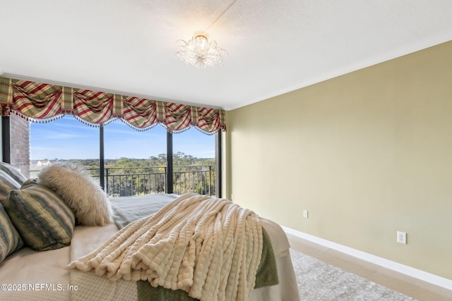 tiled bedroom with access to exterior, ornamental molding, baseboards, and an inviting chandelier