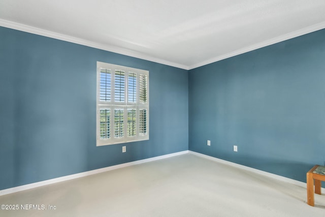 spare room featuring ornamental molding, carpet, and baseboards