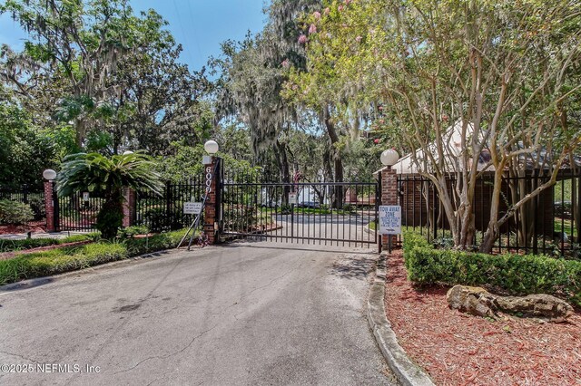 view of gate with fence