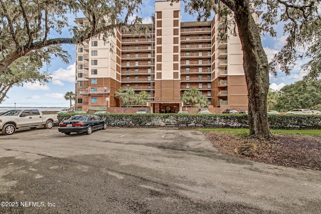 view of building exterior with uncovered parking