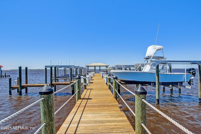 dock area with a water view and boat lift